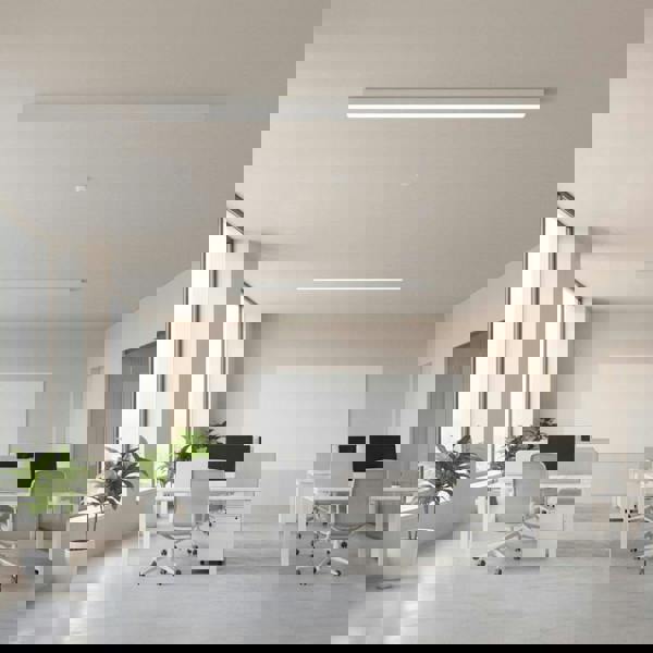 white linear surface mounted light fitted on the ceiling in an office 