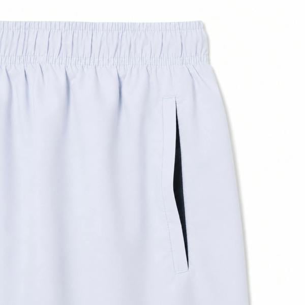 Lacoste light blue quick-dry swim shorts with elastic waistband and side pocket.