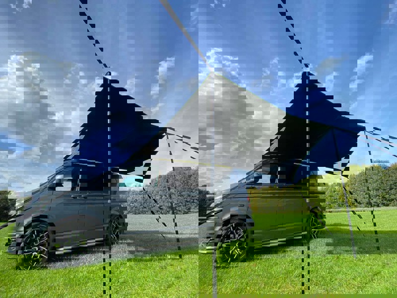 Image of Modern Shade Canopy grey with  Lime by OLPRO fitted on T5 Campervan, picture from low down left side showing the underside and space available under the canopy.