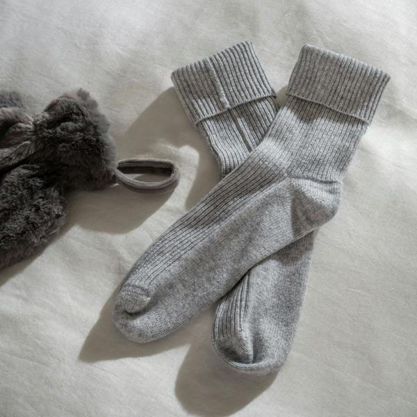 Grey Marl Supreme Cashmere Bed Socks styled in a bedroom | Soak and Sleep