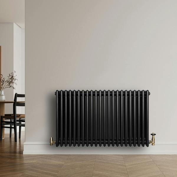 Traditional black 4 column radiator, 600 x 1010mm, featuring a sleek design with a glossy finish, mounted against a neutral wall