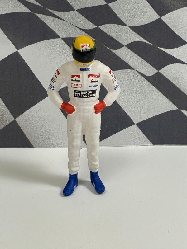 a toy figure of a race car driver