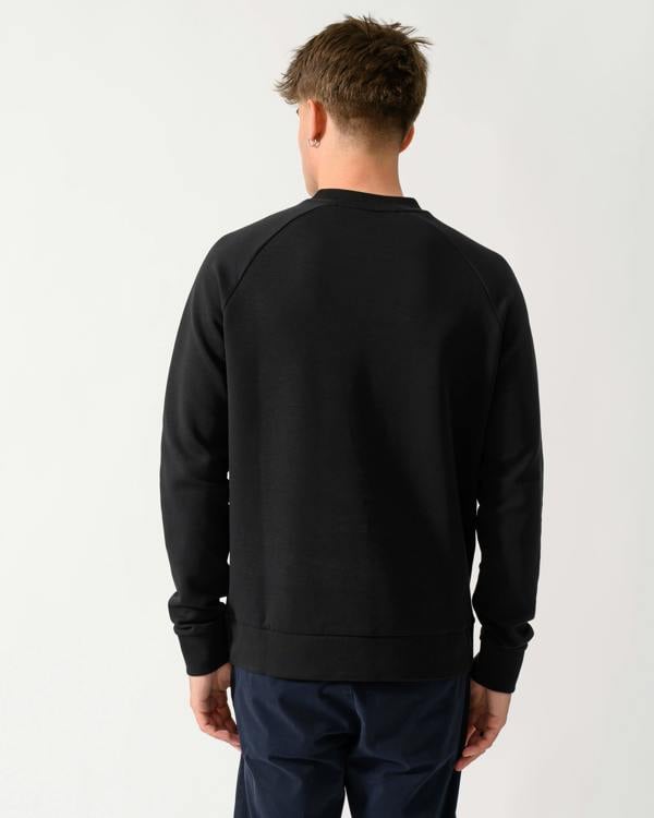 back shot of a model wearing a BOSS Green Salbo Mens Crew Neck Sweatshirt with Tonal Logo in Black 001