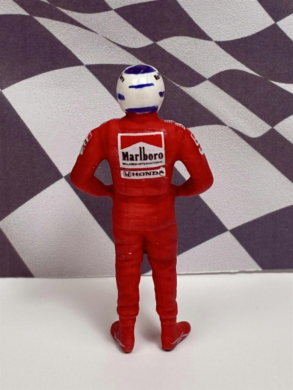 a toy figure of a man wearing a red uniform