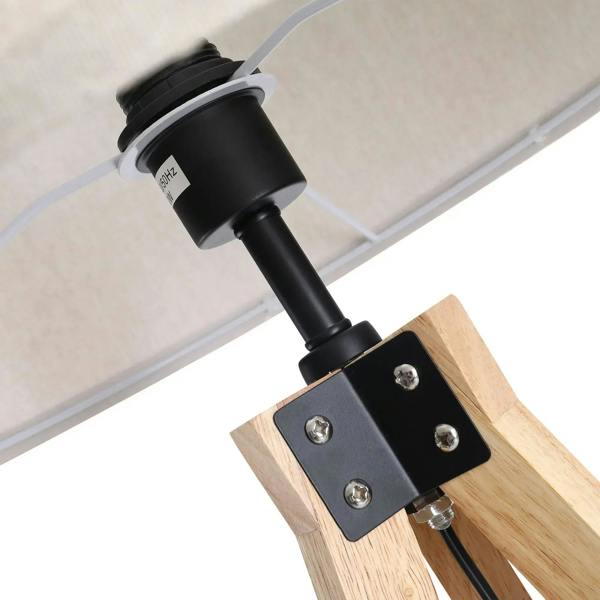Lamp socket and mounting plate on light wood tripod leg with black electrical connector