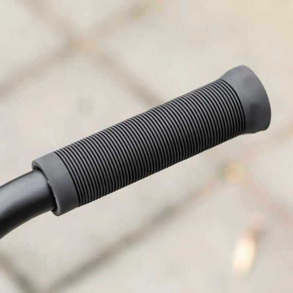 Black rubber handlebar grip sleeve on a black and gold stunt scooter handle