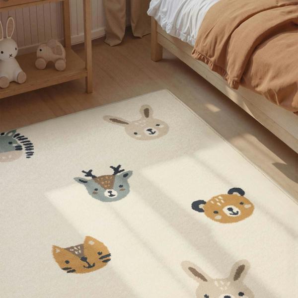Children's room with a rug featuring animal illustrations on a wooden floor.
