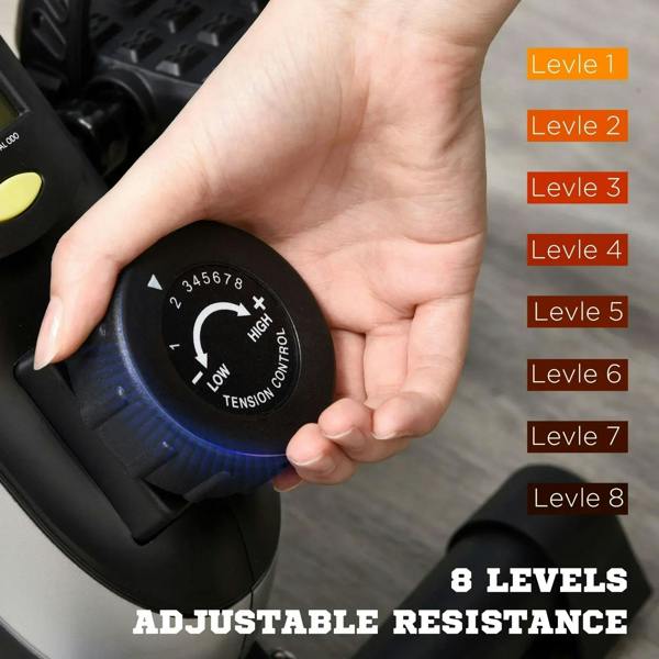Hand adjusting the round tension control dial on a black mini pedal exerciser