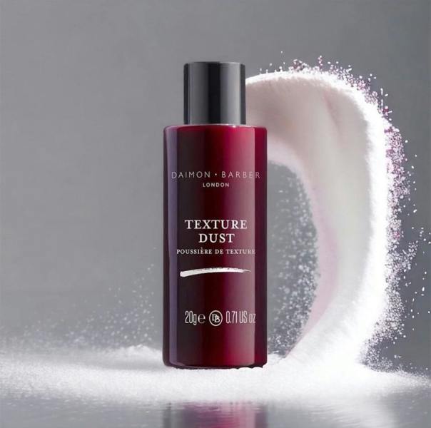 Bottle of Daimon Barber Texture Dust on grey background with powder flying in the air