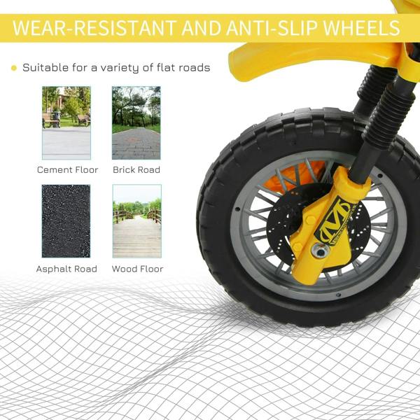 Yellow front wheel of kids electric motorcycle with tread tires and orange disc details
