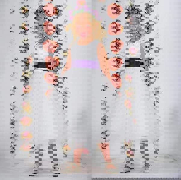 Blonde girl in a white dress with purple sash 