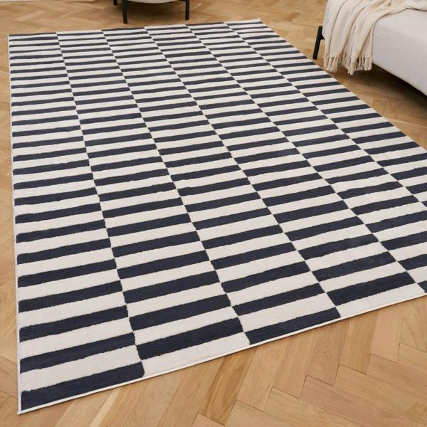Navy and white checkered rug on a wooden floor