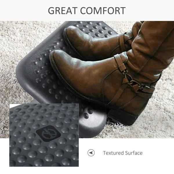 Charcoal grey footrest platform under a seated person with boots resting on top