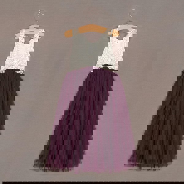 Purple dress with white lace top on a hanger against a gray background