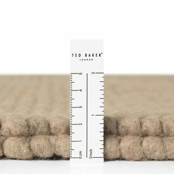 Ted Baker fabric swatch with a ruler for scale on a white background