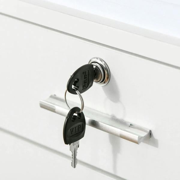 Close-up of white drawer lock with keys and metal pull handle