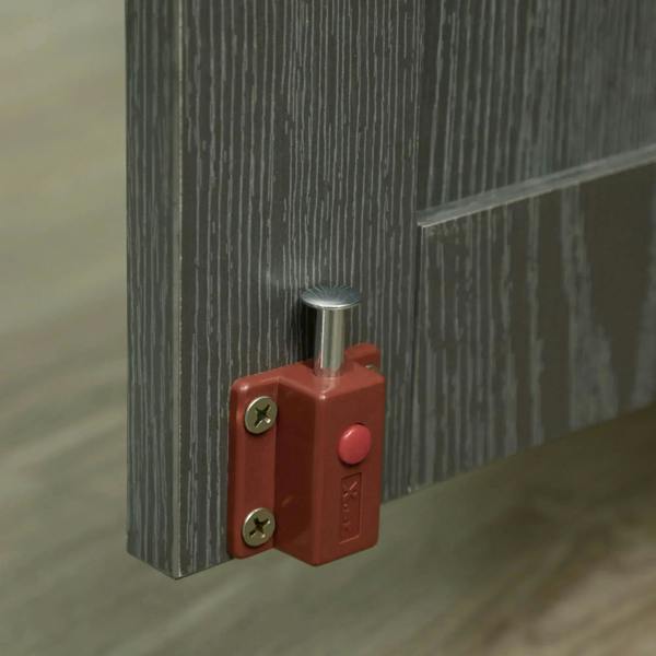 Grey dog crate table magnetic latch detail with red lock and metal pin.