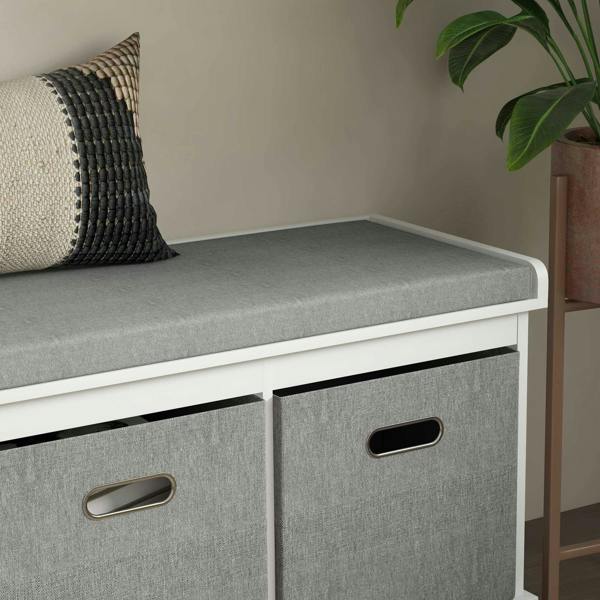 Gray drawer fronts and padded top on a white shoe storage bench with cut-out handles
