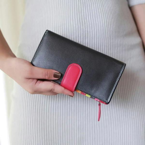 Black wallet with a pink accent held by a person on a light background