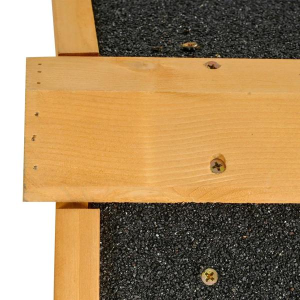 Close-up of guinea pig hutch wooden support and dark asphalt roof surface