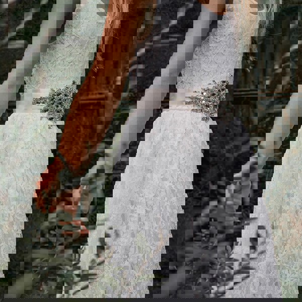 Flower girl in a Beautiful white lace dress