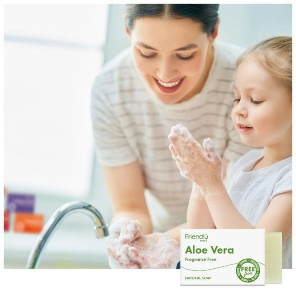 Woman and child washing hands at the kitchen sink