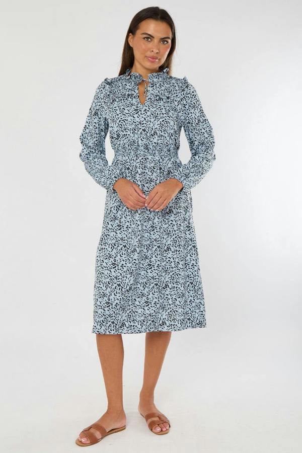 Woman wearing a blue floral dress on a white background