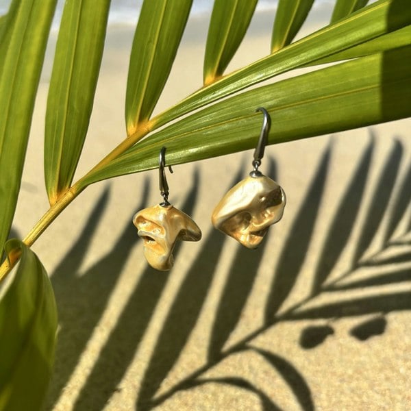 Castaway shell earrings on an exotic beach. Handcrafted in London from silver.