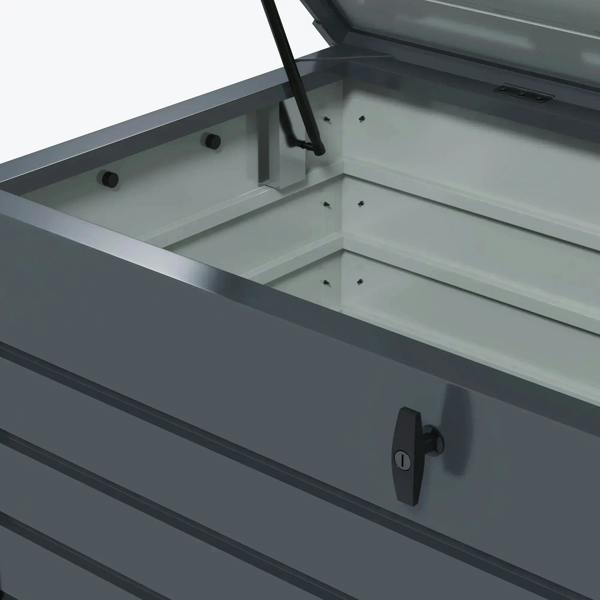Dark grey storage box interior with lid support strut and lock latch on front.