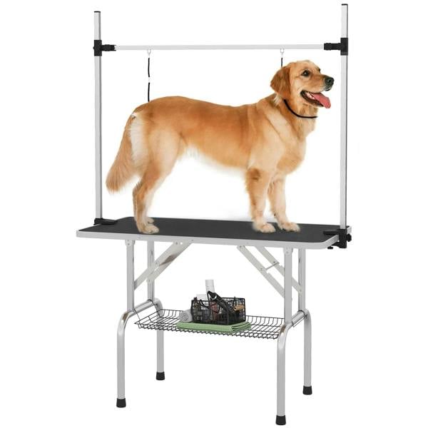 Adjustable black pet grooming table with rubber top, hanging loops, and storage basket