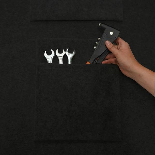 Black storage pouches featuring a textured surface, holding various tools like wrenches and a hand tool for organized storage