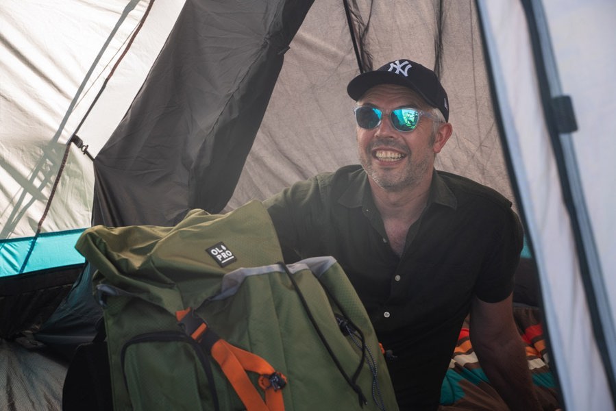 An image of a male with an OLPRO Rucksack whilst sat inside of the Stafford 4.0 OLPRO x Ed Stafford.