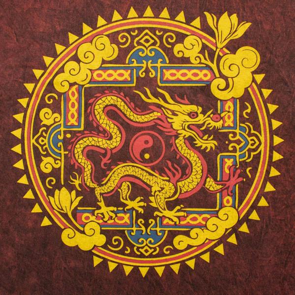 Maroon t-shirt fabric close-up with yellow dragon mandala emblem