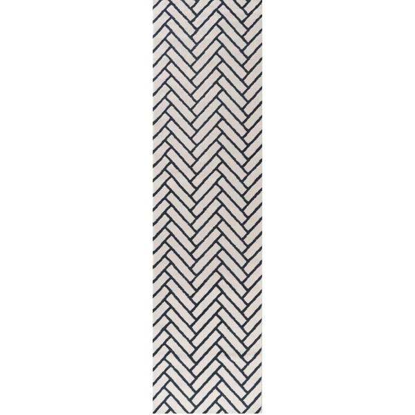 Black and white chevron patterned rug on a white background