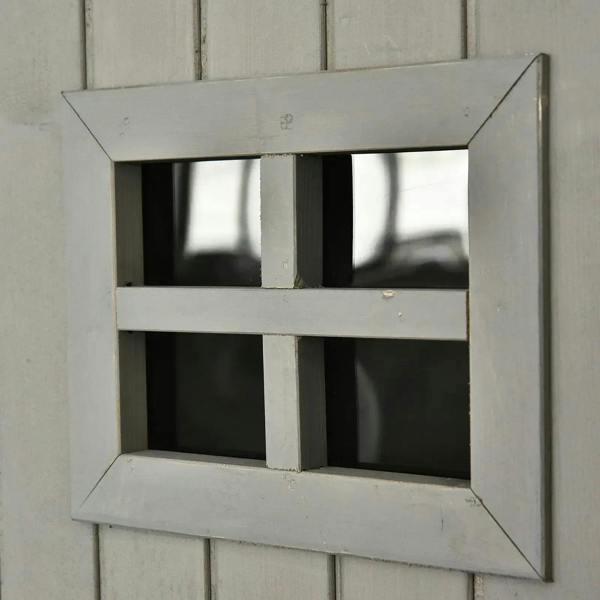 Grey wooden shed windowed opening showing two dark shelf compartments
