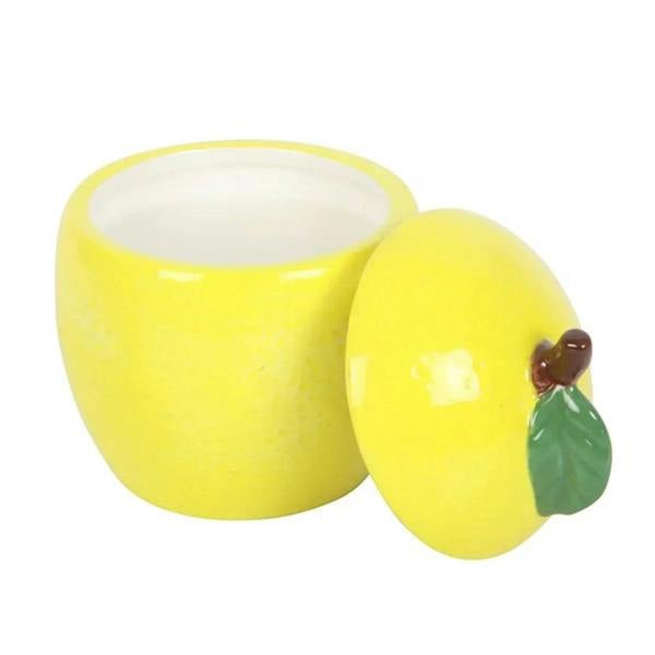 Yellow lemon candle jar and matching jar with leaf lid, glossy ceramic, lid open.