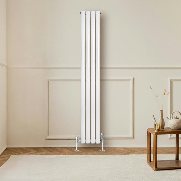 Sleek white oval single column radiator, 1600 x 240mm, mounted on a wall in a modern room with wooden flooring and minimal decor