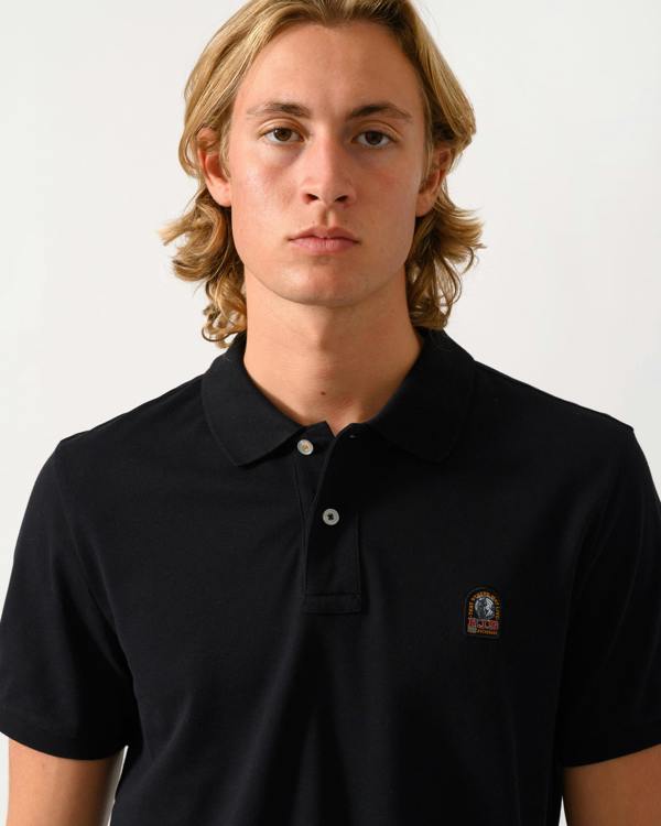 close up of a model wearing Parajumpers Wellington Mens Short Sleeve Polo in Black 541