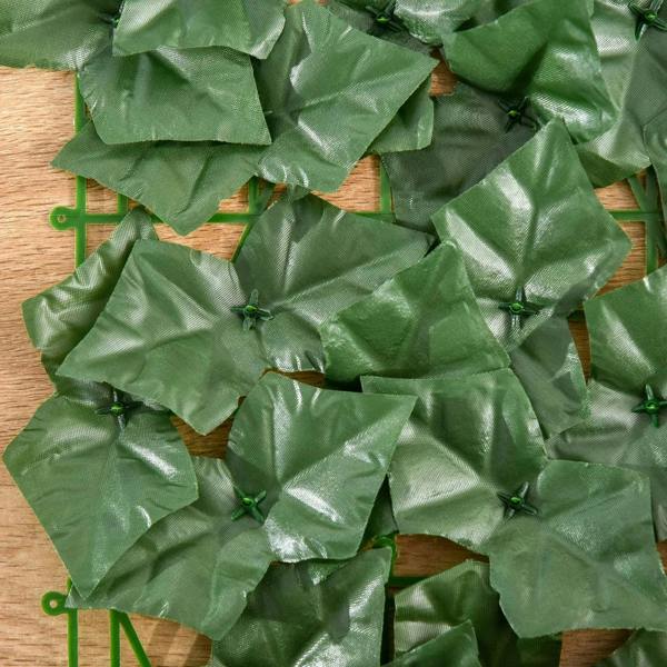 Dark green artificial hedge screen panel close-up with crinkled leaf texture
