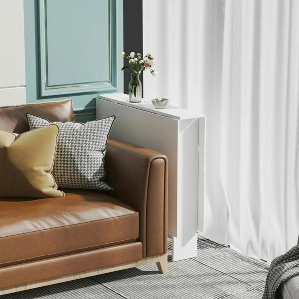 White folding table console with teak wood panel on the front, next to sofa