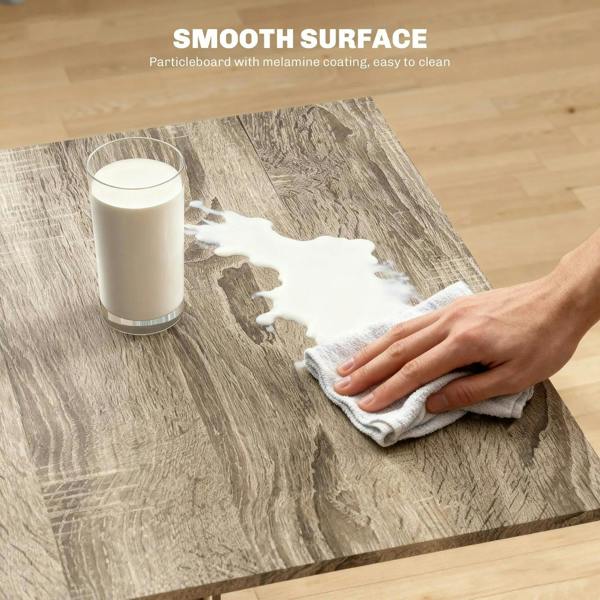 Grey folding dining table top with smooth melamine finish, wiped with cloth