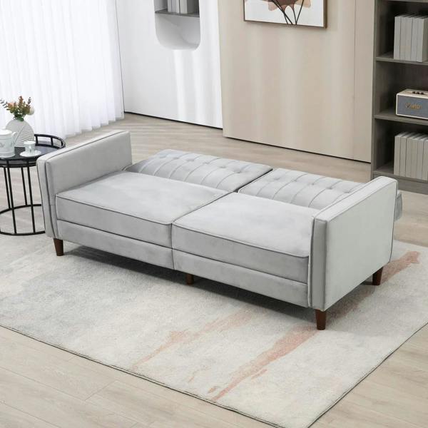 Light grey convertible sofa transformed into a flat futon lounge with tufted back sections