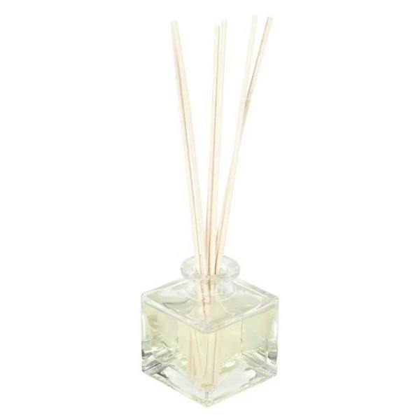 Clear glass reed diffuser with four pale wooden reeds