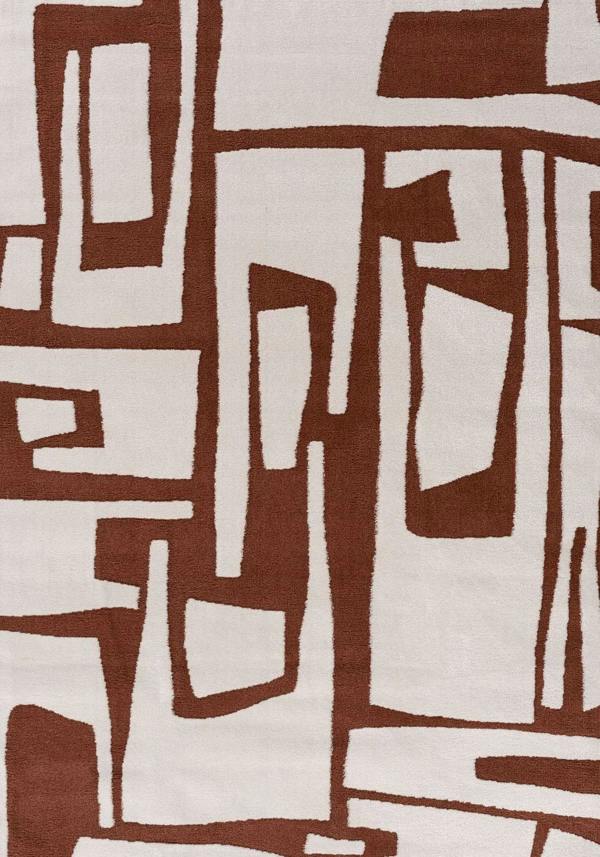 Abstract pattern of brown and beige shapes on a textured fabric background