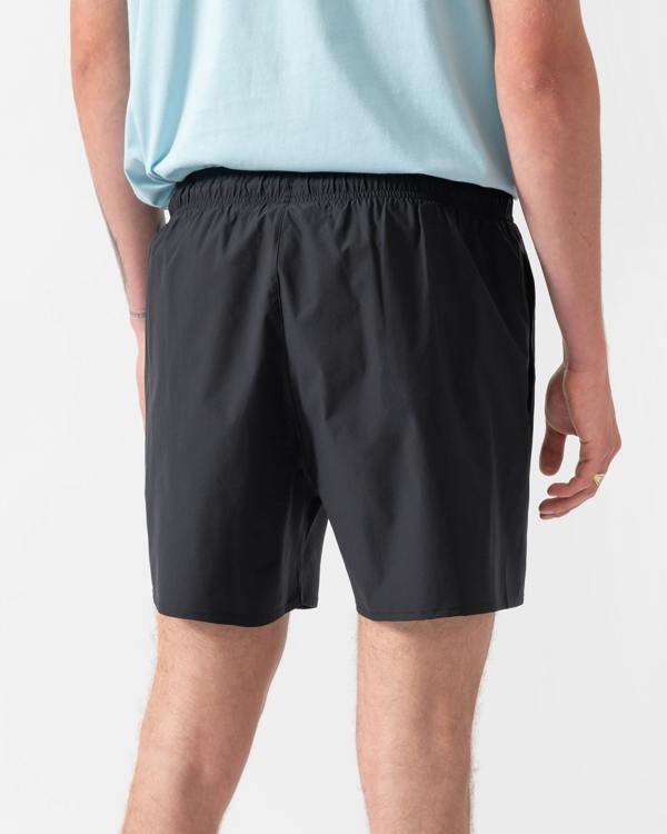 model wearing a pai of Emporio Armani Mens Swim Shorts with Eagle Logo in Black