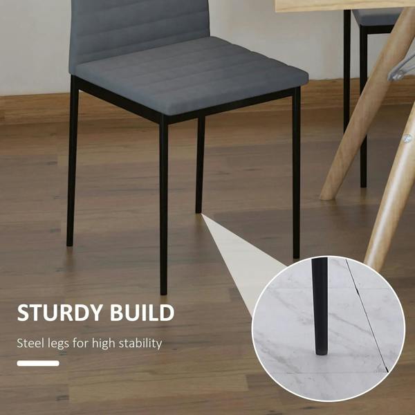 Grey dining chair with steel legs for stability, close-up of leg base