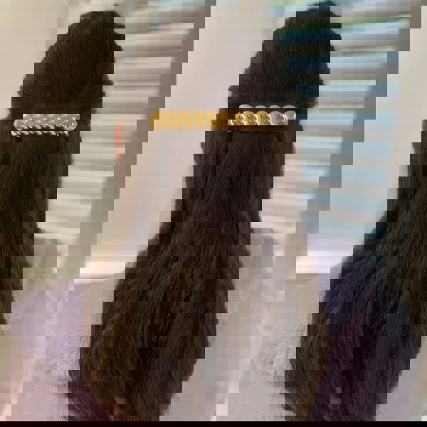 Gold barrette hair clip, large twisted bar design, polished metallic finish, secure clasp fastening, half-up hairstyle accessory, elegant decorative hair piece
