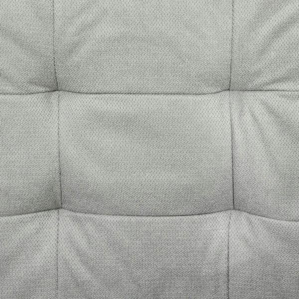 Light grey upholstered sofa seat cushion with stitched padded panels, close-up