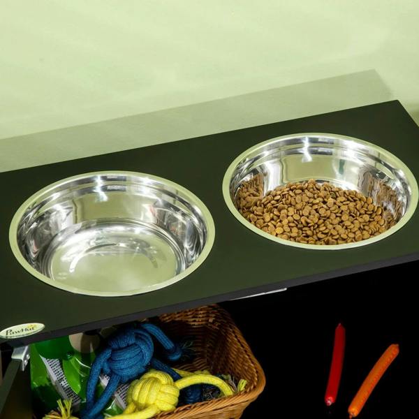 Close-up of two stainless steel bowls on a black raised pet feeder top.