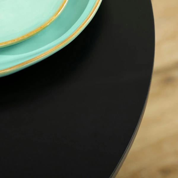 Black tabletop side profile with smooth curved edge and pedestal leg opening
